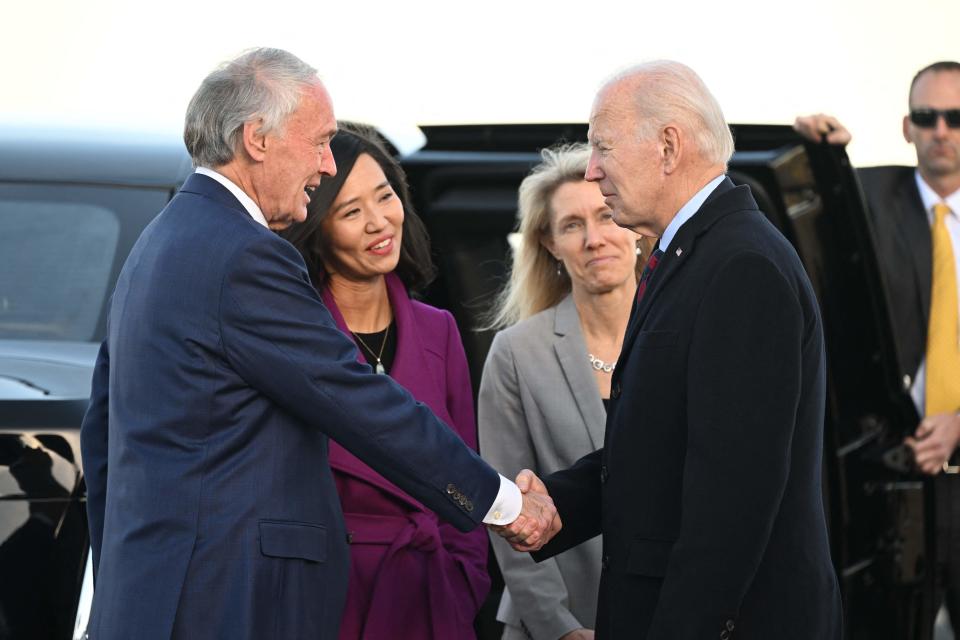 US President Joe Biden is greeted by US Senator Ed Markey and Boston Mayor Michelle Wu (2nd L) on arrival at Boston Logan International Airport on December 2, 2022, in Boston, Massachusetts (AFP via Getty Images)