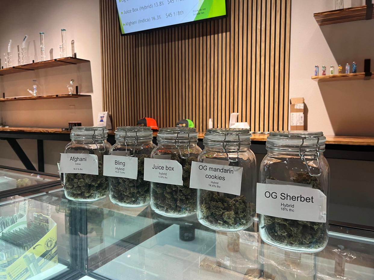 Glass jars display different types of medical marijuana and cannabis products that can be purchased at Flower Shop Dispensary in Sioux Falls on Sept. 5, 2022.