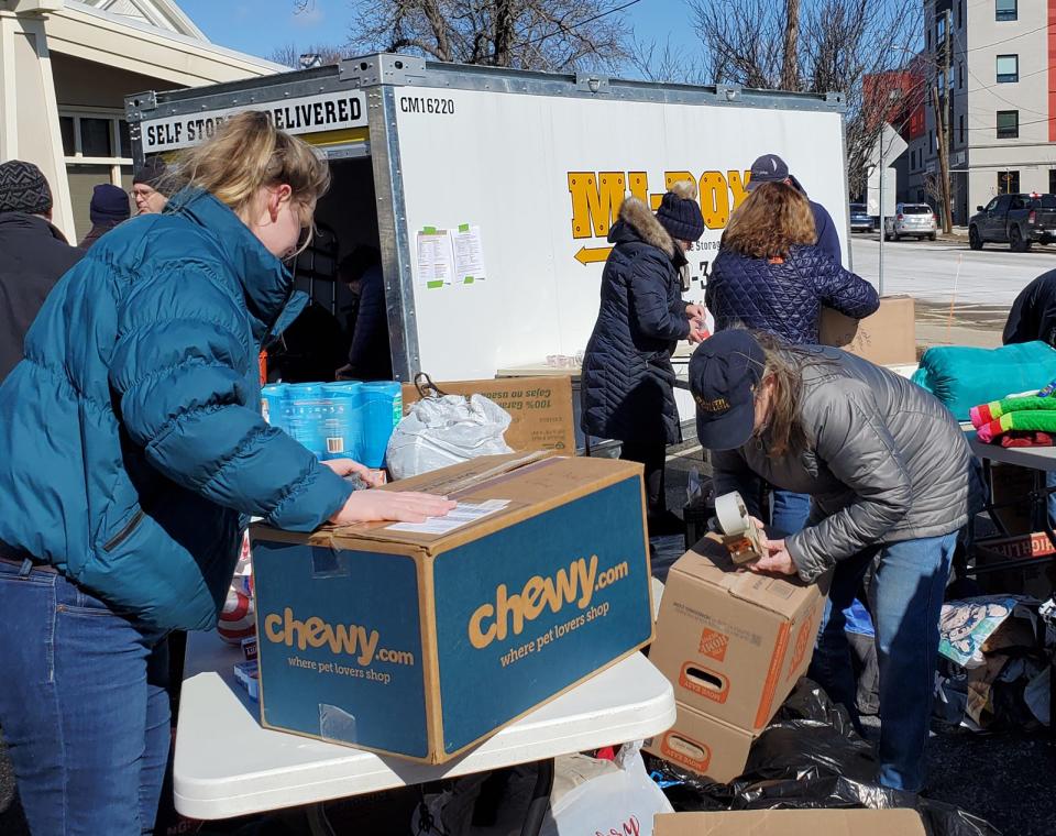 Volunteers package donated items to be shipped to Ukraine outside the Greater Dover Chamber of Commerce Sunday, March 13, 2022.