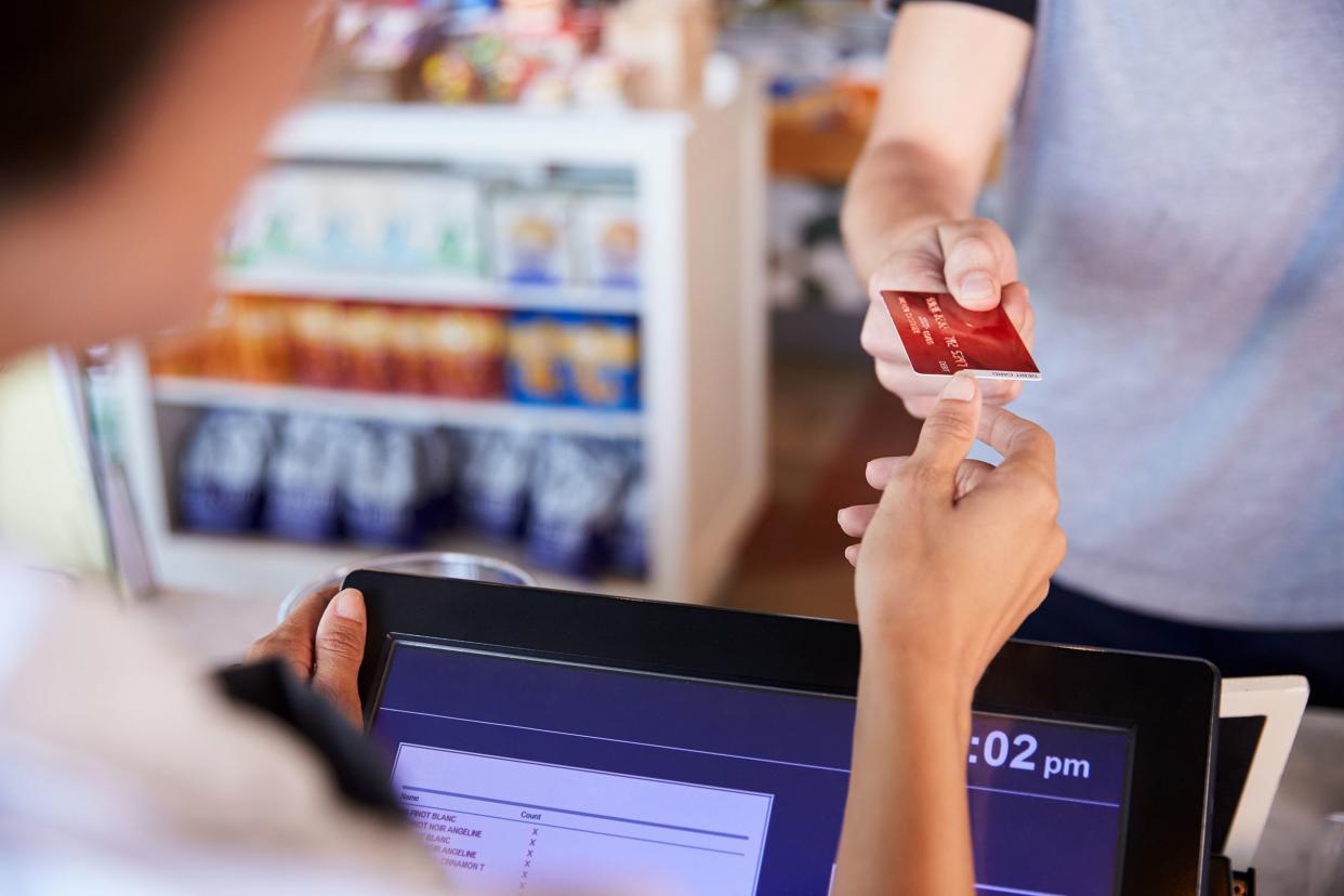 cashier accepts card payment from customer