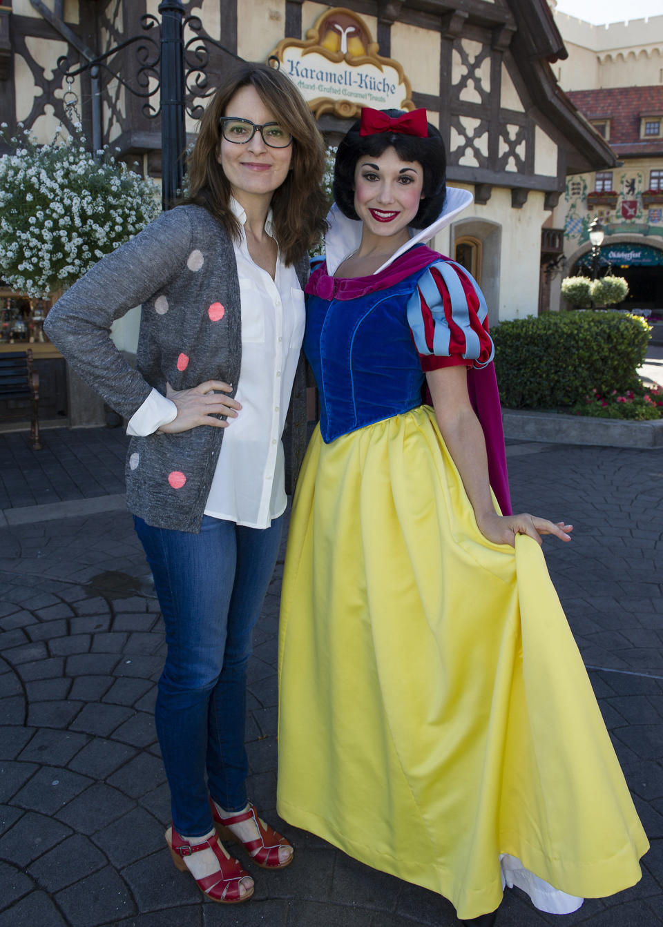 Tina Fey poses with Snow White in the Germany pavilion at Epcot February 18, 2013 in Lake Buena Vista, Florida.  Epcot is one of four theme parks at the Walt Disney World Resort.  (Photo by Gene Duncan/Disney Parks via Getty Images)