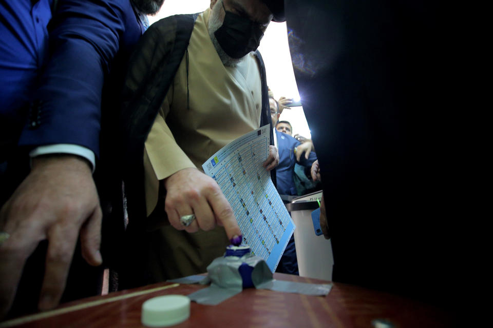 Populist Shiite cleric Muqtada al-Sadr casts his vote during parliamentary elections in Najaf, Iraq, Sunday, Oct. 10, 2021. Iraq closed its airspace and land border crossings on Sunday as voters headed to the polls to elect a parliament that many hope will deliver much needed reforms after decades of conflict and mismanagement. (AP Photo/Anmar Khalil)