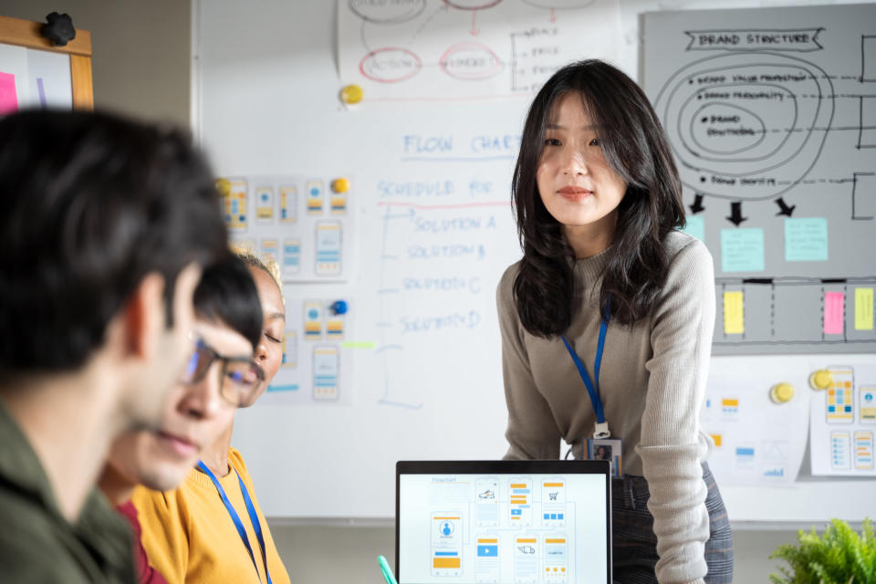 A woman presenting with her computer in front of people