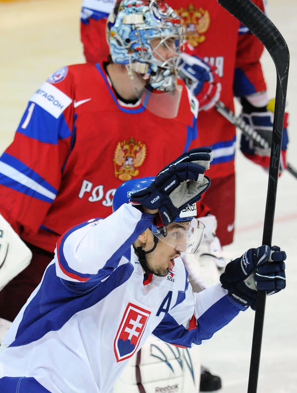 Slovakia's Miroslav Satan celebrates Zdeno Chara's score against team Russia during the final game of the IIHF International Ice Hockey World Championship in Helsinki on May 20, 2012. AFP PHOTO/ ALEXANDER NEMENOVALEXANDER NEMENOV/AFP/GettyImages