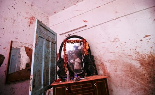 A relative of 23-year-old Palestinian Enas Khammash, who was killed with her toddler in an Israeli air strike inspects their bedroom in Deir Al-Balah in the central Gaza Strip on August 9, 2018