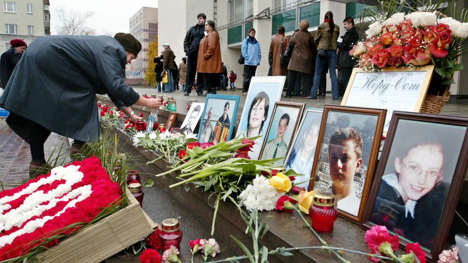 A woman puts a portrait of her relative in front of the Dubrovka Theater in Moscow, October 26, 2004, where Chechen commandos took hundreds of hostages. Most of the 130 civilian victims of the siege died as a result of a deadly gas that Russian special forces used as they stormed the theater. - Denis Sinyakov/AFP/Getty Images