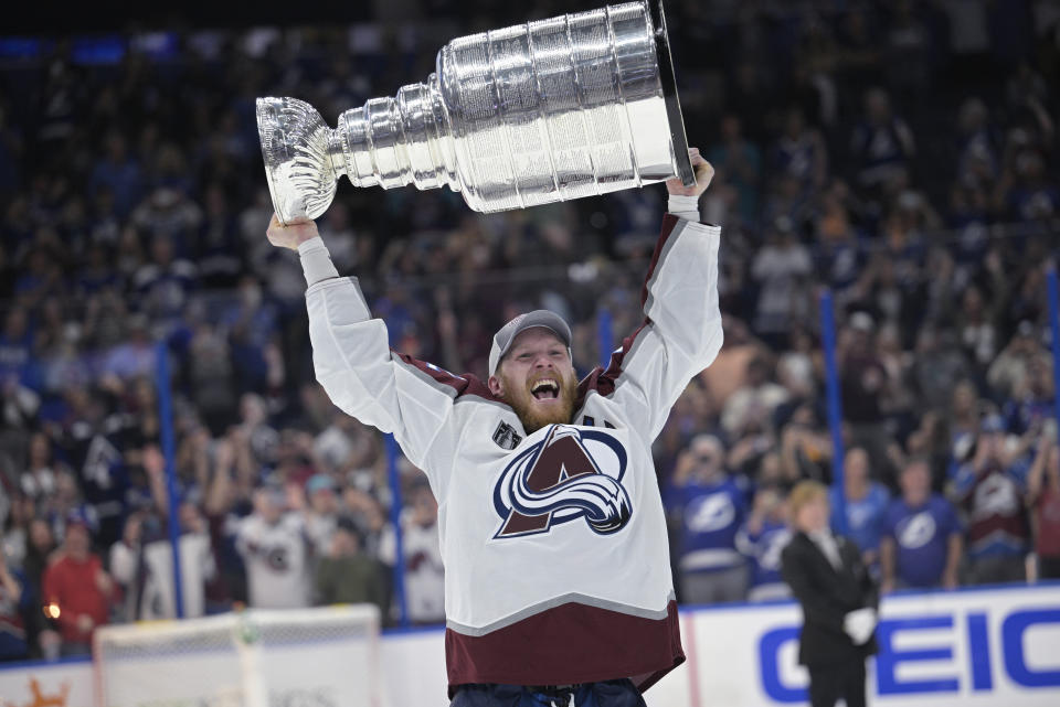 FILE - Colorado Avalanche's Gabriel Landeskog lifts the Stanley Cup after the team defeated the Tampa Bay Lightning in Game 6 of the NHL hockey Stanley Cup Finals on June 26, 2022, in Tampa, Fla. The Avalanche will have to try to defend their Stanley Cup championship without Landeskog. The team announced Thursday, April 13, that Landeskog will not take part in the playoffs because of a knee injury that caused him to miss the entire regular season. (AP Photo/Phelan M. Ebenhack, File)