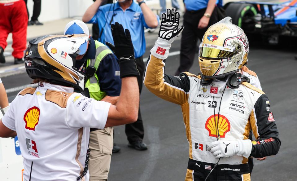 Team Penske driver Josef Newgarden (2) high fives a pit crew member during the Pit Stop Challenge on Carb Day before the 106th running of the Indianapolis 500 on Friday, May 27, 2022, at the Indianapolis Motor Speedway in Indianapolis. 