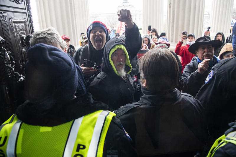 Rioters attempt to enter the US Capitol at the House steps during a joint session of Congress to certify the Electoral College vote.