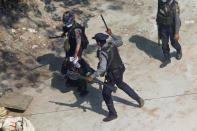 FILE - Police officers hold down a protester as they disperse demonstrators in Tharkata Township on the outskirts of Yangon, Myanmar, March 6, 2021. The prospects for peace in Myanmar, much less a return to democracy, seem dimmer than ever two years after the army seized power from the elected government of Aung San Suu Kyi, experts say. (AP Photo, File)