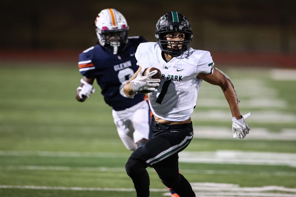 Cedar Park's Tyree Nicholson races away from Glenn defenders in Cedar Park's 21-10 district victory Friday at Bible Stadium. Nicholson scored two touchdowns and had 149 yards from scrimmage.