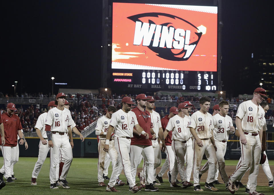 Arkansas players walk off the field after losing to Oregon State in Game 2 of the NCAA College World Series baseball finals in Omaha, Neb., Wednesday, June 27, 2018. (AP Photo/Nati Harnik)