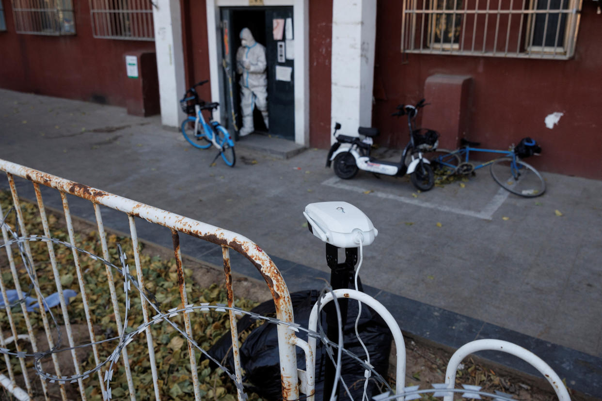 A temporarily installed camera points at a door to an apartment building where residents are under lockdown as outbreaks of COVID-19 continue in Beijing. 