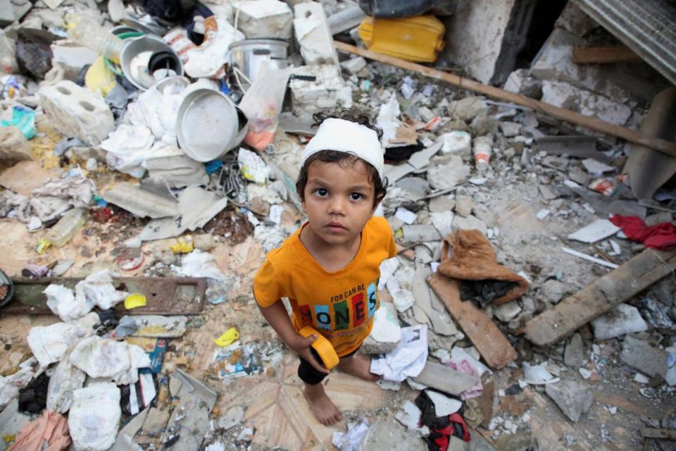 A wounded Palestinian boy reacts at the site of an Israeli strike on a house in Rafah (Reuters)