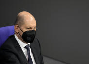 German Chancellor Olaf Scholz attends a debate about a vaccination mandate at the parliament Bundestag in Berlin, Germany, Wednesday, Jan. 26, 2022. (AP Photo/Markus Schreiber)