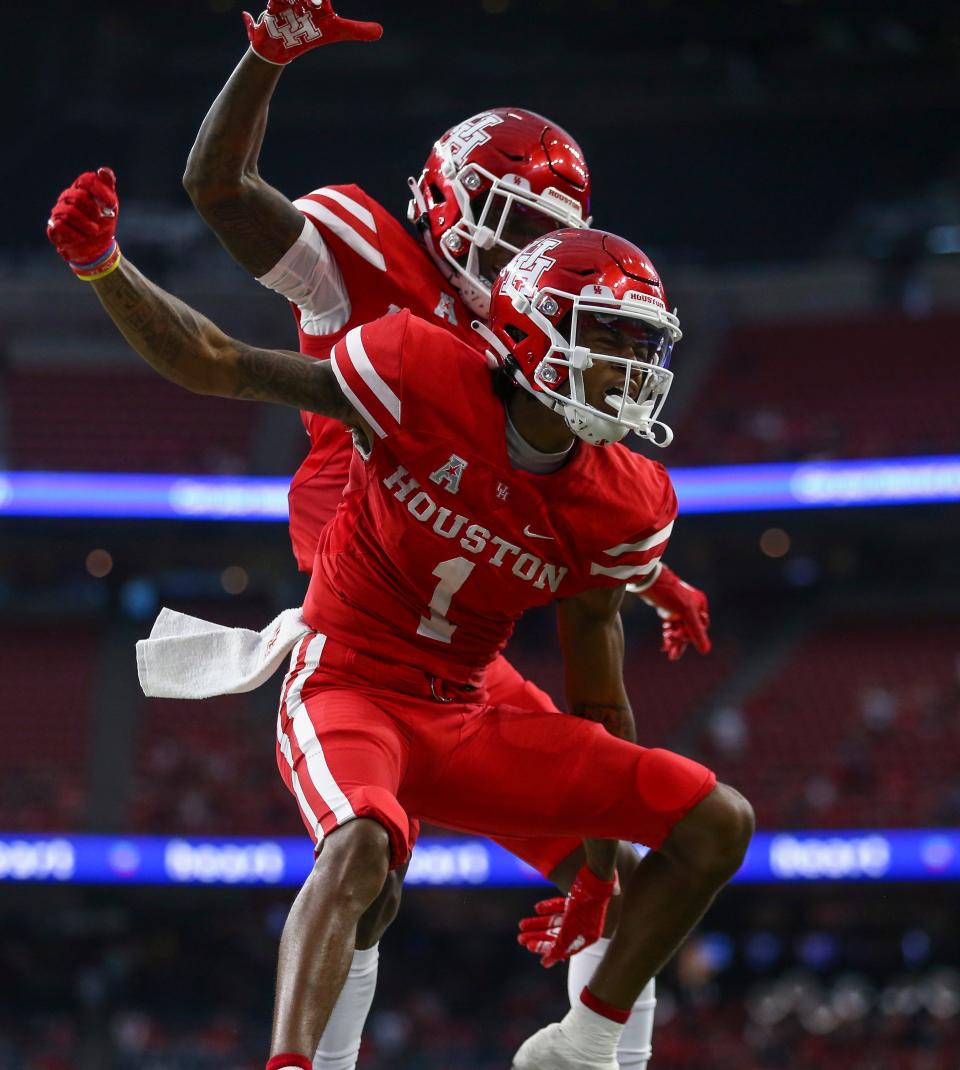 Houston Cougars wide receiver Nathaniel Dell (1) celebrates after making a touchdown reception during the first quarter against the Texas Tech Red Raiders at NRG Stadium.
