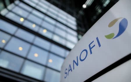 A logo is seen in front of the entrance at the headquarters French drugmaker Sanofi in Paris October 30, 2014. REUTERS/Christian Hartmann