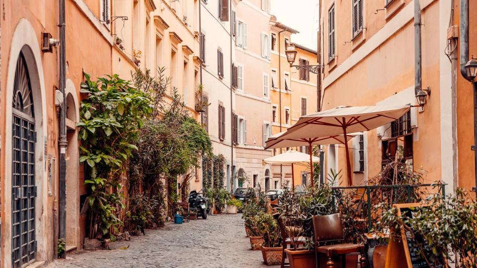 alley with restaurants in trastevere district, rome, italy