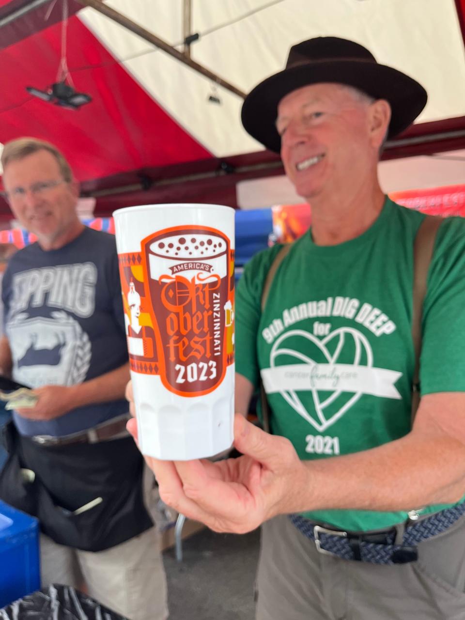 Buy an Oktoberfest souvenir mug at a beer booth.