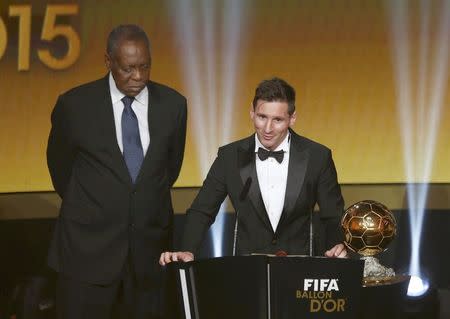 FC Barcelona's Lionel Messi of Argentina receives the FIFA Ballon d'Or 2015 for the world player of the year, as FIFA acting President Issa Hayatou (L) watches, during an awards ceremony in Zurich, Switzerland, January 11, 2016 REUTERS/Arnd Wiegmann