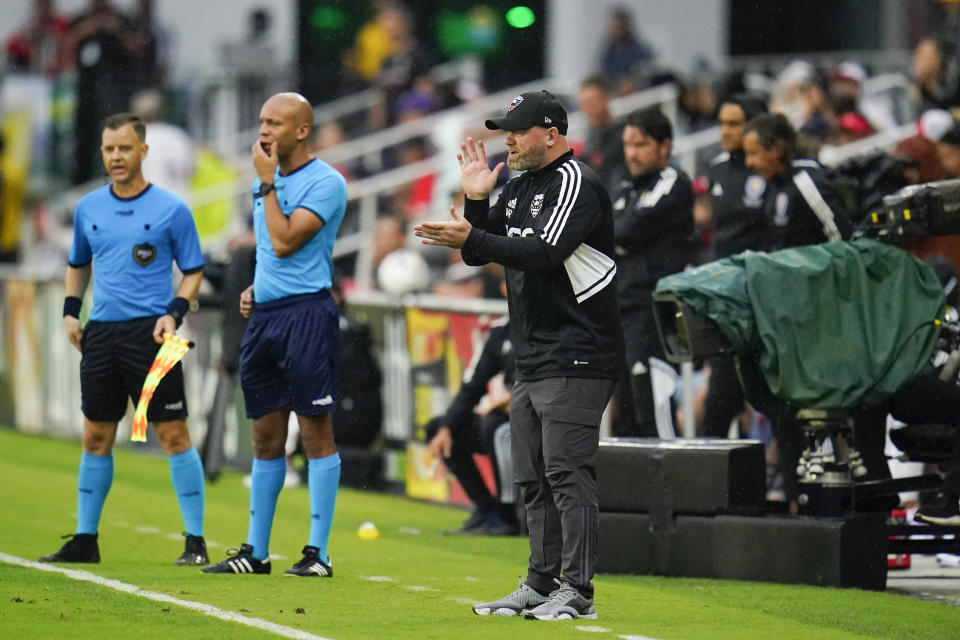 D.C. United head coach Wayne Rooney, center, reacts during the second half of an MLS soccer match against Orlando City, Sunday, July 31, 2022, in Washington. D.C. United won 2-1. (AP Photo/Julio Cortez)