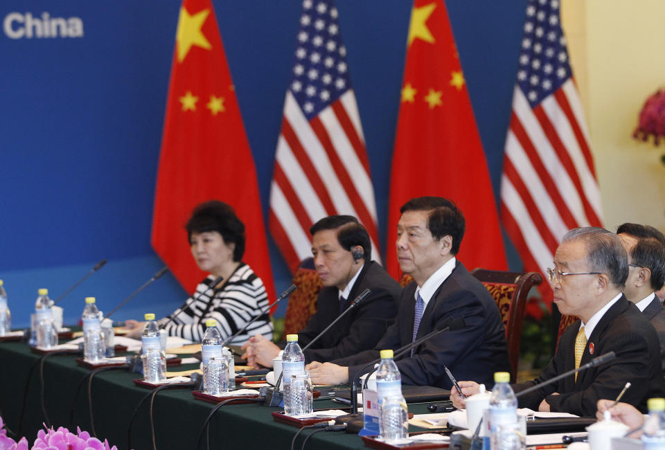 BEIJING, CHINA - MAY 3: China's State Councilor Dai Bingguo (R) talks with U.S. Secretary of State Hillary Clinton (not seen) during a plenary session of U.S.-China Strategic and Economic Dialogue at the Diaoyutai State Guesthouse on May 4, 2012 in Beijing. Hillary Clinton is in China for bilateral talks and has called on China to protect human rights. (Photo by Shannon Stapleton/Pool/Getty Images)