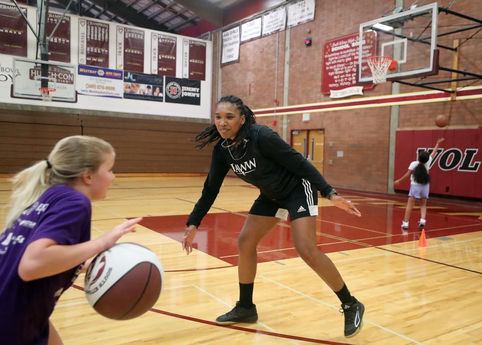 Ashli Payne, a member of the incoming Kitsap Sports Hall of Fame class, now coaches with Port Orchard-based RAWW Athletics, working with young athletes in Kitsap County. In this photo from August she leads a basketball camp at South Kitsap High School.