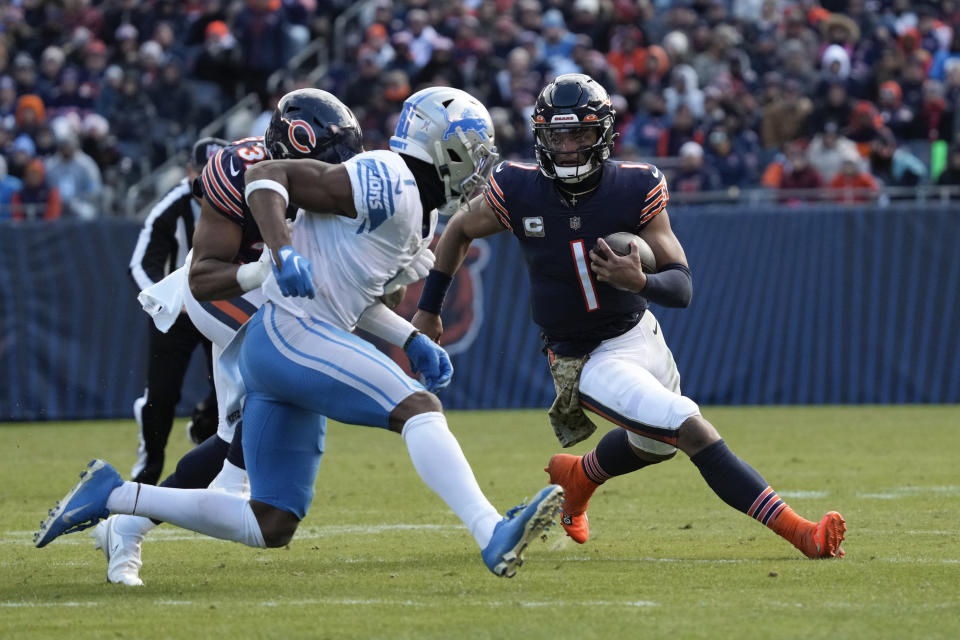 Chicago Bears quarterback Justin Fields (1) runs the ball as Detroit Lions cornerback Jeff Okudah (1) pursues during the first half of an NFL football game in Chicago, Sunday, Nov. 13, 2022. (AP Photo/Nam Y. Huh)