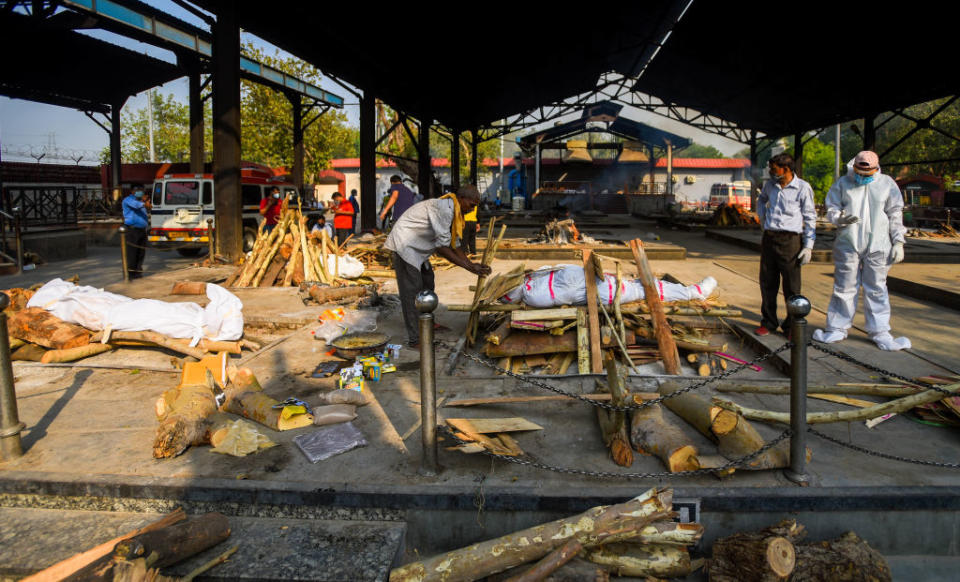 Funeral pyres are prepared during cremations of people who died due to coronavirus infection earlier this month in New Delhi. Source: Getty