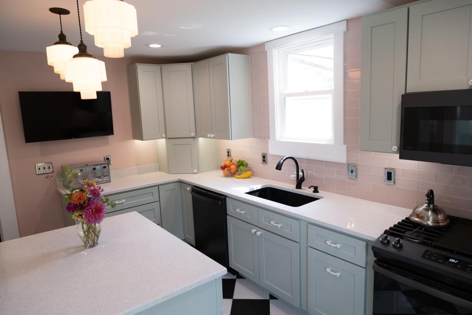 Sweetly complementing the green is pale pink paint on the walls and even paler pink glass subway tiles as a backsplash in this renovated kitchen in Louisville's Clifton neighborhood.