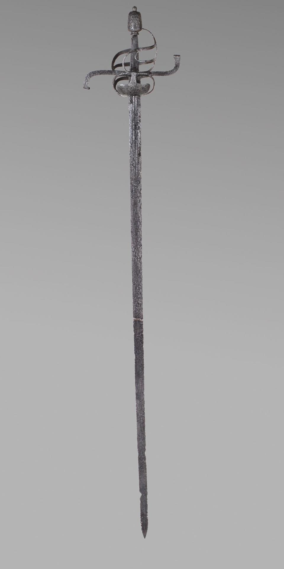 long thin metal sword with thin flowing guard spiraling around the handle