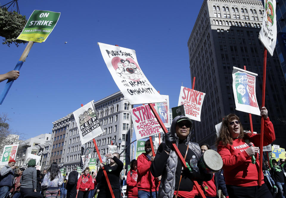 Teachers, students and supporters march in Oakland, Calif., Thursday, Feb. 21, 2019. Teachers in Oakland, California, went on strike Thursday in the country's latest walkout by educators over classroom conditions and pay. (AP Photo/Jeff Chiu)