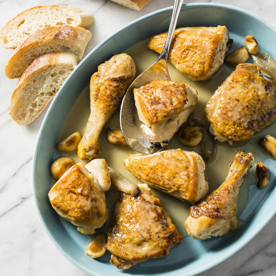 This undated photo provided by America's Test Kitchen in March 2019 shows Chicken With 40 Cloves Of Garlic. The recipe appears in the cookbook "How to Braise Everything." (Steve Klise/America's Test Kitchen via AP)