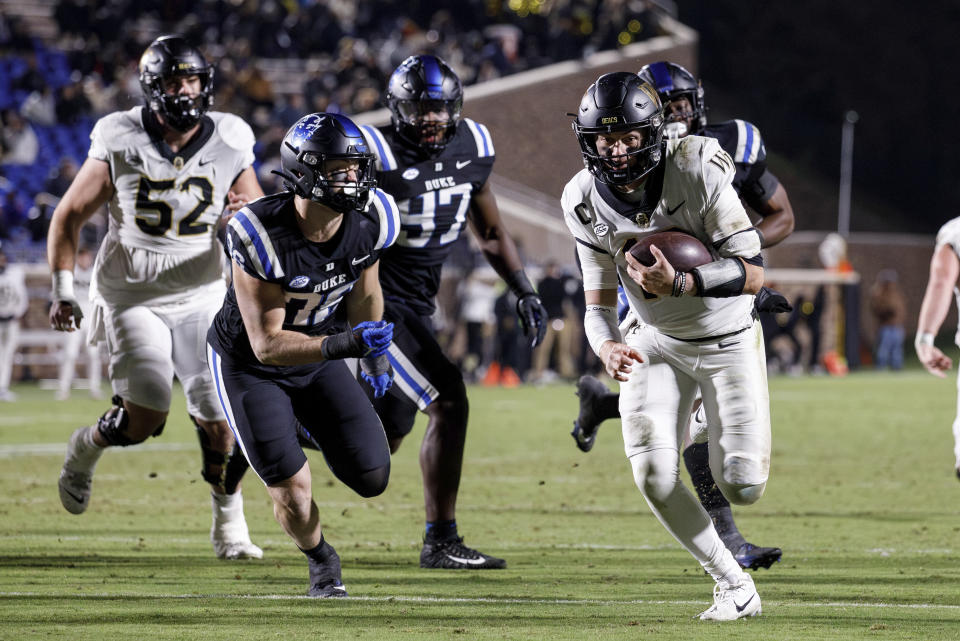 Wake Forest's Mitch Griffis, right, carries the ball for a touchdown past Duke's Nick Morris Jr. (36) during the first half of an NCAA college football game against Duke in Durham, N.C., Thursday, Nov. 2, 2023. (AP Photo/Ben McKeown)