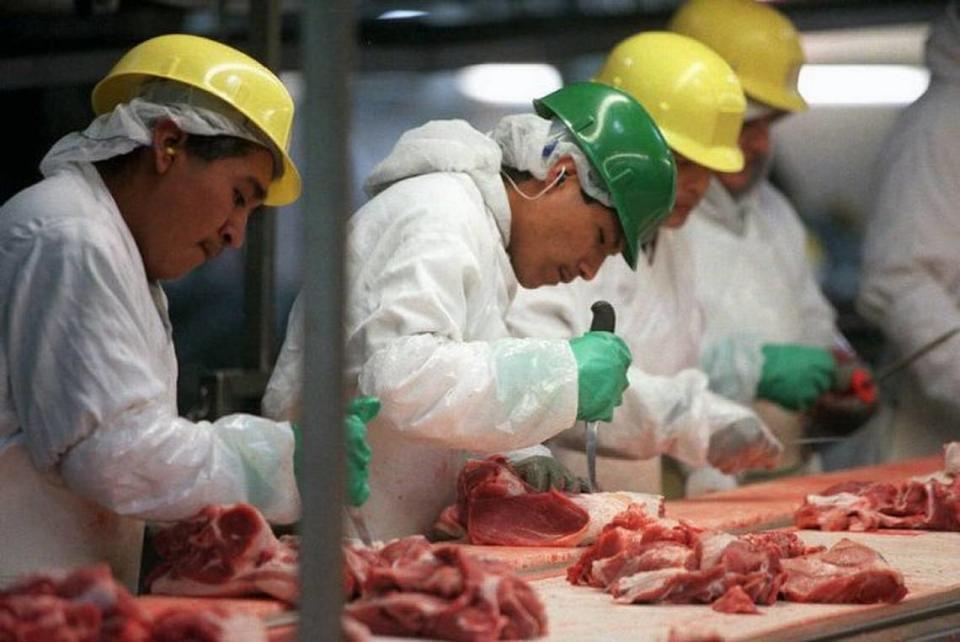 “Picnic line” workers cut pork from shoulder bones in the Smithfield Foods processing plant in Tar Heel. The company is moving its Charlotte operations to the facility in Bladen County. EDWARD KEATING/NYT