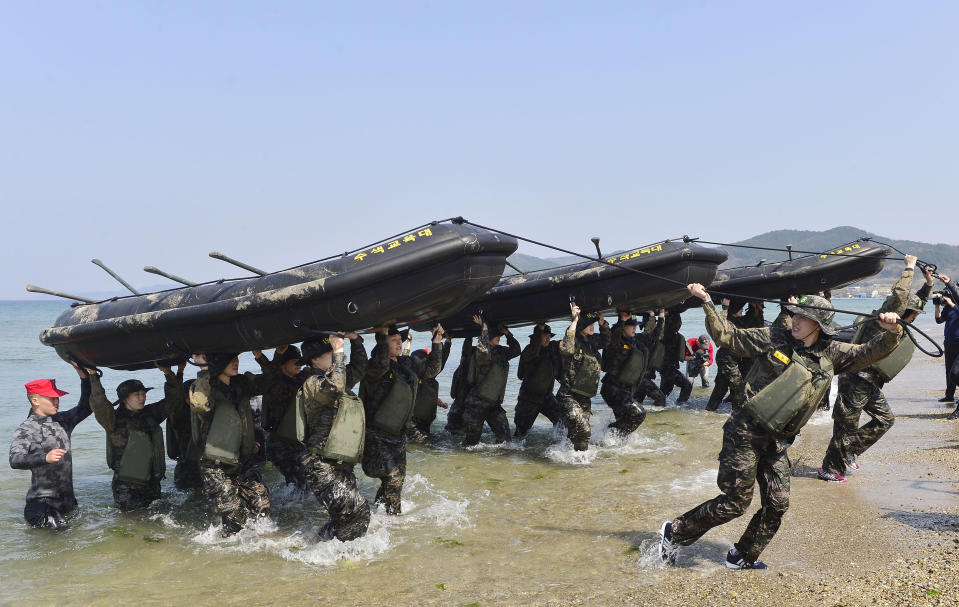 Members of the women's South Korean national handball team perform a team-building exercise with rubber boats during physical training at a boot camp for the Marine Corps in Pohang, South Korea, on March 30, 2016. (Choe Dong-joon/Newsis via AP)