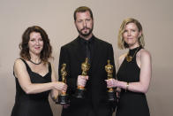 Raney Aronson-Rath, from left, Mstyslav Chernov, and Michelle Mizner pose in the press room with the award for best documentary feature film for "20 Days in Mariupol" at the Oscars on Sunday, March 10, 2024, at the Dolby Theatre in Los Angeles. (Photo by Jordan Strauss/Invision/AP)