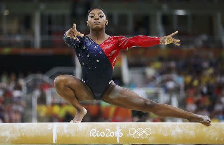 Simone Biles competes on the beam during the women's qualifications. REUTERS/Damir Sagolj