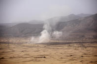 Smoke rises from a Houthi missile attack near the Kassara frontline during clashes with Yemeni fighters backed by the Saudi-led coalition, in Marib, Yemen, Sunday, June 20, 2021. (AP Photo/Nariman El-Mofty)