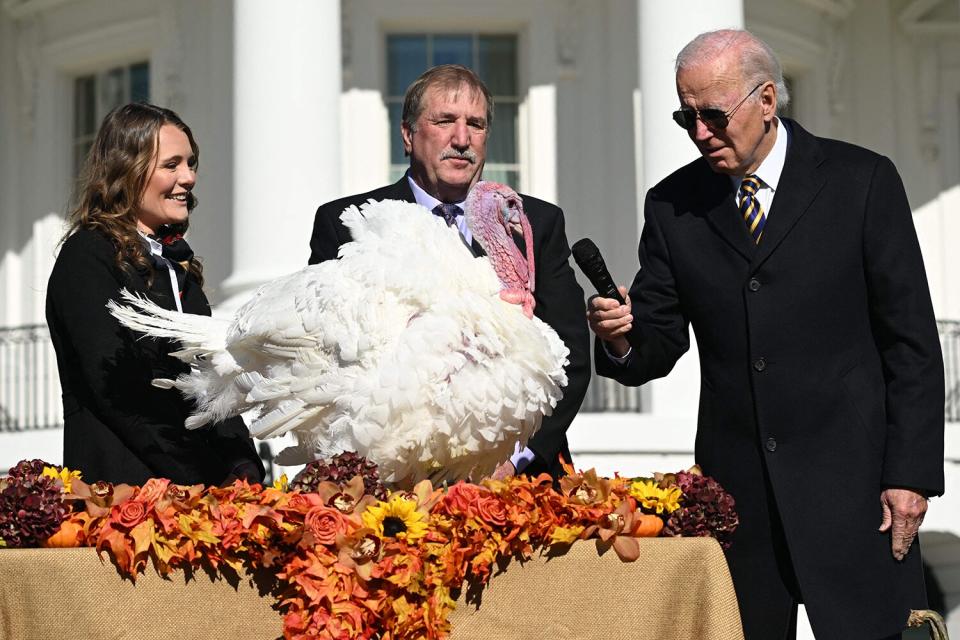 US President Joe Biden pardons Chocolate, the National Thanksgiving Turkey, as he is joined by the National Turkey Federation Chairman Ronnie Parker (C) on the South Lawn of the White House in Washington, DC on November 21, 2022.