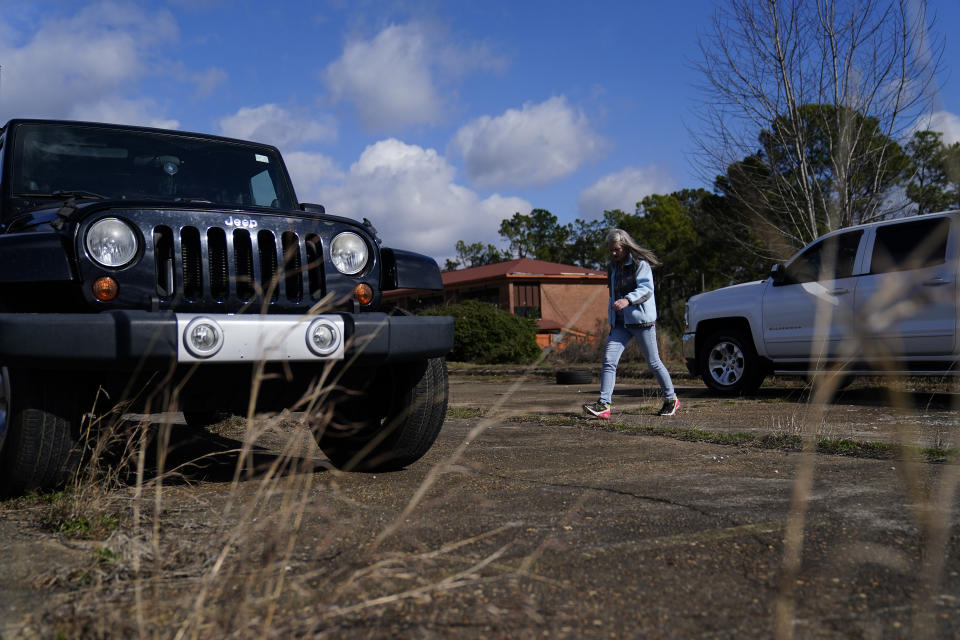 Jessie Blanchard walks near her jeep, outside of a motel where she hands out goods like Naloxone, tourniquet, needles, food, and other materials to help the community on Monday, Jan. 23, 2023, in Albany, Ga. In 2022, she handed out more than 1,800 doses — far more than the public health district for Southwest Georgia, which gave out 280 doses to people who showed up at health department offices in an isolated corner of Albany and to community organizations. (AP Photo/Brynn Anderson)