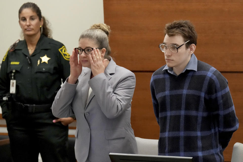 Assistant Public Defender Nawal Bashimam and Marjory Stoneman Douglas High School shooter Nikolas Cruz stand as jurors enter the courtroom during the penalty phase of Cruz's trial at the Broward County Courthouse in Fort Lauderdale, Fla., Monday, Aug. 29, 2022. Cruz previously plead guilty to all 17 counts of premeditated murder and 17 counts of attempted murder in the 2018 shootings. (Amy Beth Bennett/South Florida Sun Sentinel via AP, Pool)