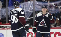 Colorado Avalanche right wing Mikko Rantanen, left, congratulates defenseman Bowen Byram after his goal against the Nashville Predators in the second period of an NHL hockey game Saturday, Nov. 27, 2021, in Denver. (AP Photo/David Zalubowski)