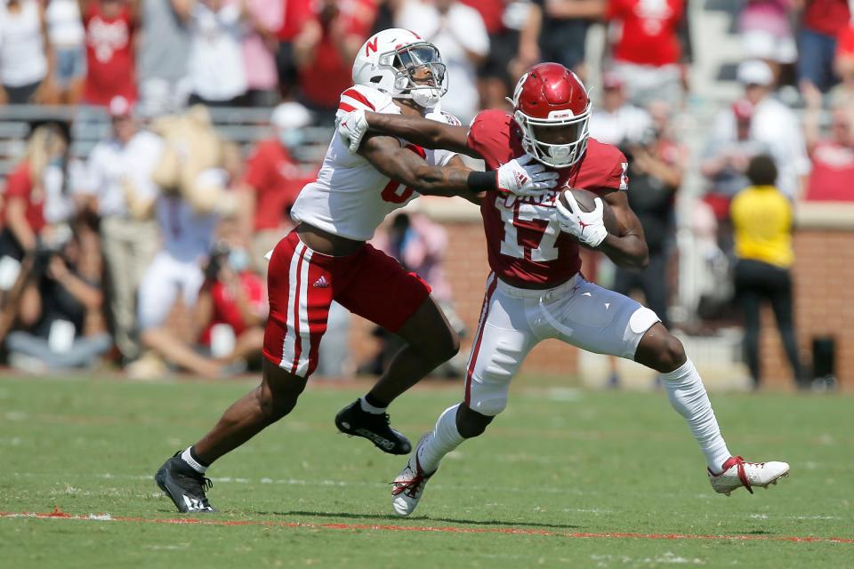 OU's Marvin Mims tries to break free from Nebraska's Quinton Newsome during the Sooners' eventual 23-16 victory last September. BRYAN TERRY/The Oklahoman