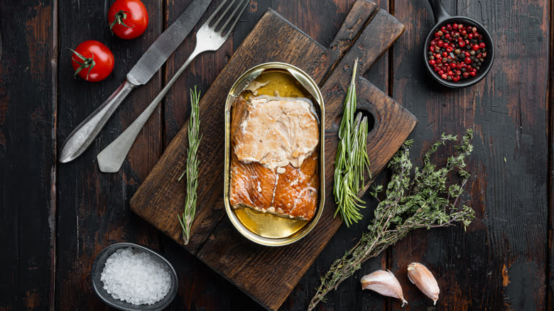 Canned salmon in oil on cutting board