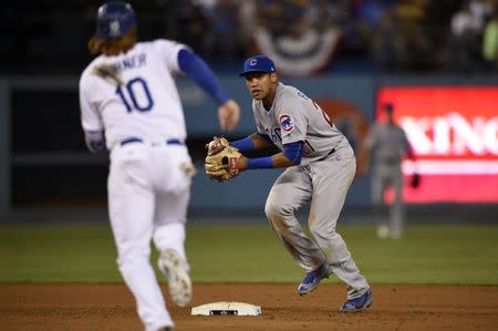 Oct 20, 2016; Los Angeles, CA, USA; Chicago Cubs shortstop Addison Russell (27) turns a double play in the eighth inning against the Los Angeles Dodgers of game five of the 2016 NLCS playoff baseball series against the Los Angeles Dodgers at Dodger Stadium. Mandatory Credit: Kelvin Kuo-USA TODAY Sports