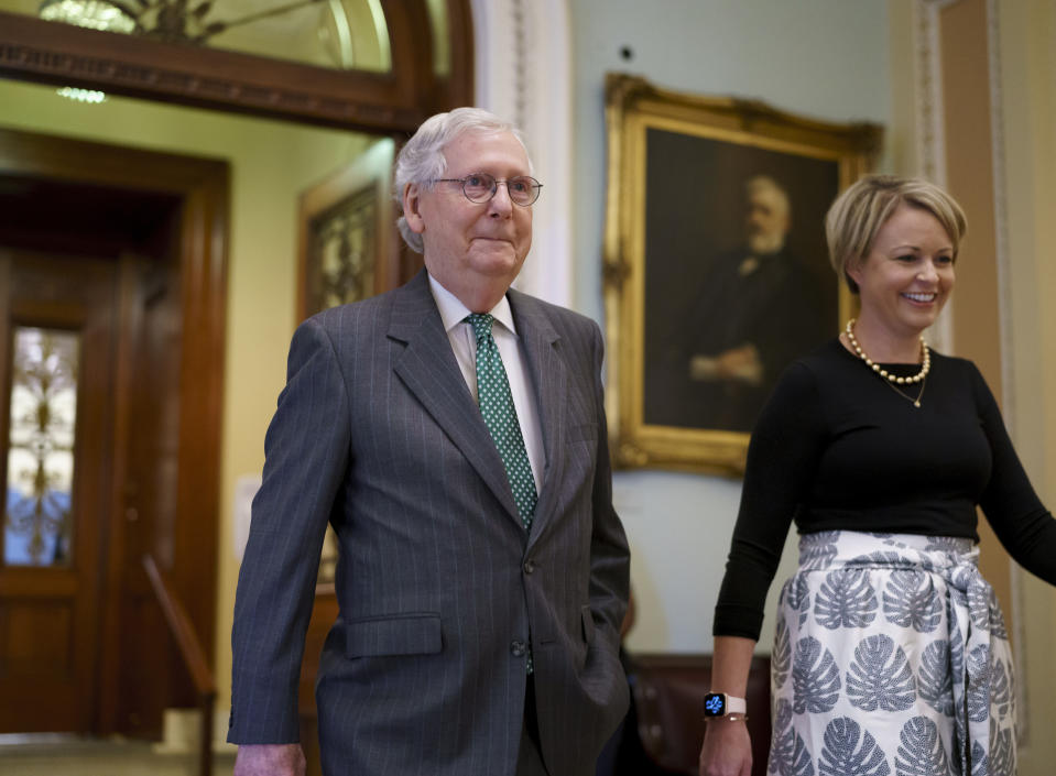 Senate Minority Leader Mitch McConnell, R-Ky., leaves the chamber, joined by top aide Stefanie Muchow, right, as lawmakers work to advance the $1 trillion bipartisan bill, at the Capitol in Washington, Thursday, Aug. 5, 2021. (AP Photo/J. Scott Applewhite)