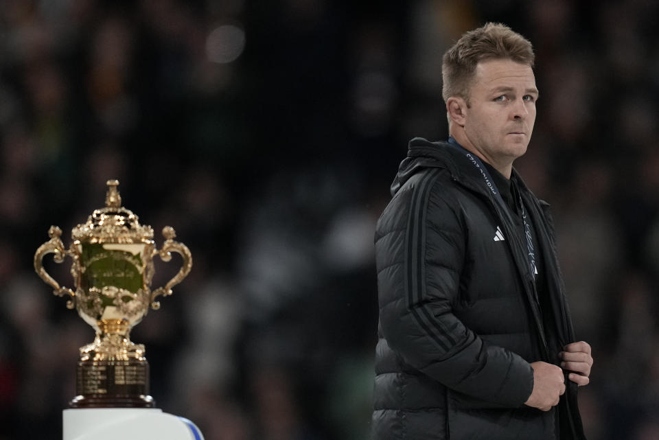 New Zealand's Sam Cane walks past the trophy during presentation ceremony after the Rugby World Cup final match between New Zealand and South Africa at the Stade de France in Saint-Denis, near Paris Saturday, Oct. 28, 2023. South Africa won the match 12-11. (AP Photo/Thibault Camus)