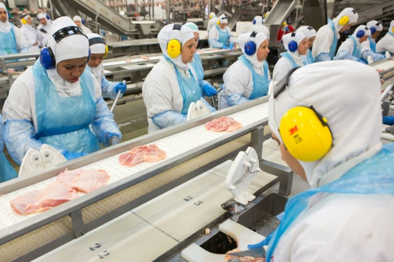 People work at a production line of the JBS-Friboi chicken processing plant during an inspection visit from Brazilian Agriculture Minister Blairo Maggi and technicians of the ministry in Lapa, Parana State, Brazil on March 21, 2017