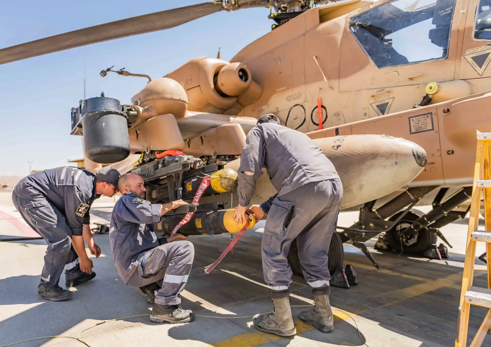 Armorers load a Hellfire missile on an Israeli AH-64. <em>IAF</em>